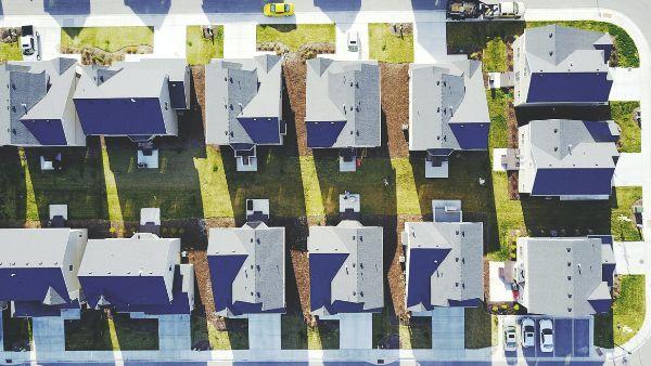 Aerial photography of rows of houses by Blake Wheeler